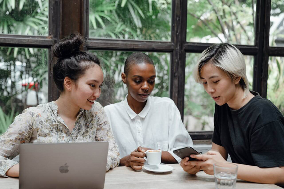 friends gathered around a smartphone